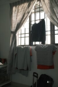 Start with a warm, well-lit space for dressing. Additionally, remove distractions and extra clothing items hanging on wardrobes and elsewhere. This helps reduce confusion and makes the process smoother.